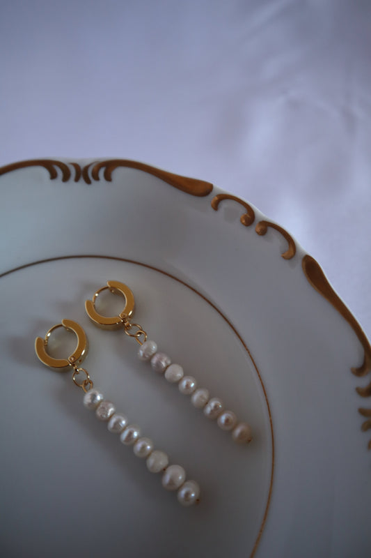 18-k-gold-plated-huggies-hoops-dangle-freshwater-pearls-earrings-lifestyle-photo-on-jewelry-dish