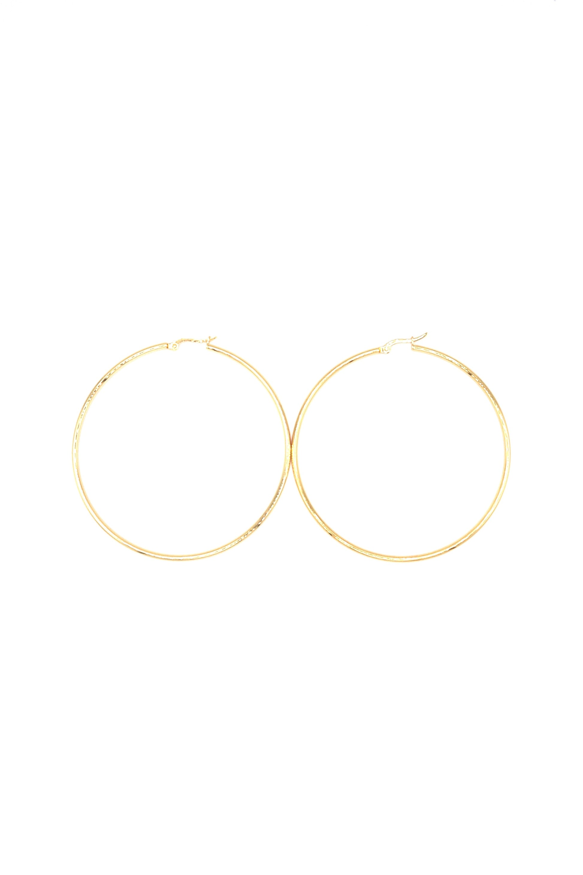 Gold plated large hoop earrings displayed flat