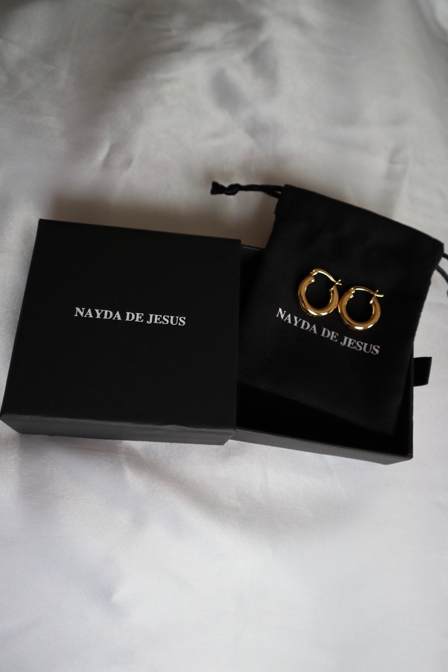 21mm 18K gold plated hoop earrings displayed on Nayda De Jesus jewelry box