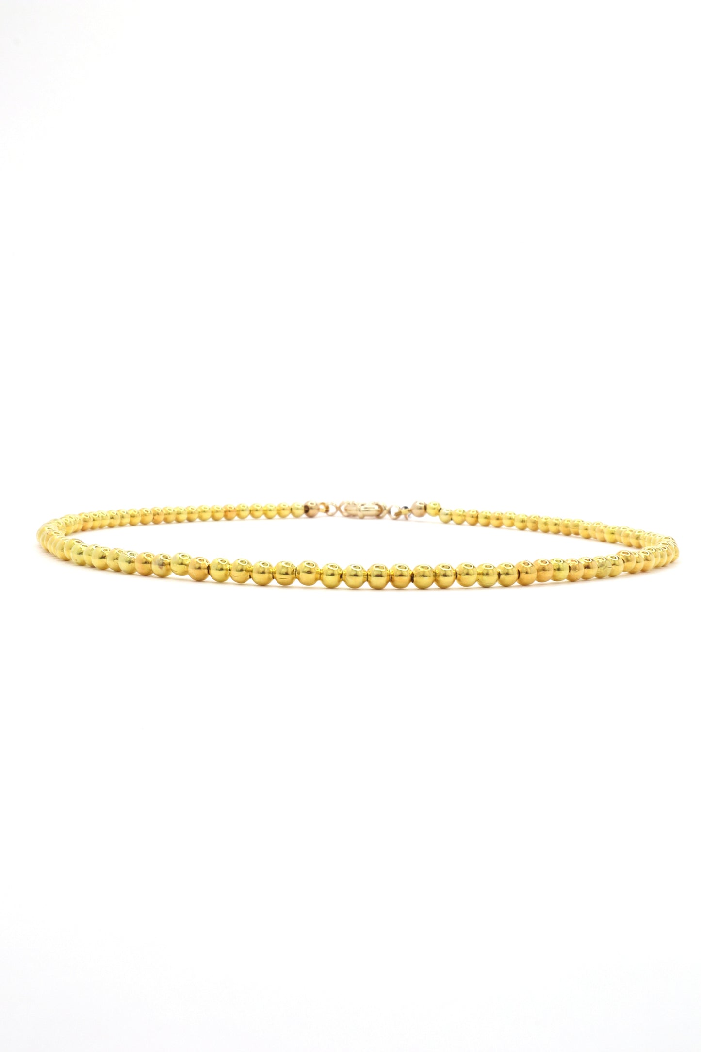 close-up of 22k gold plated beaded necklace handmade on white background by Nayda De Jesus