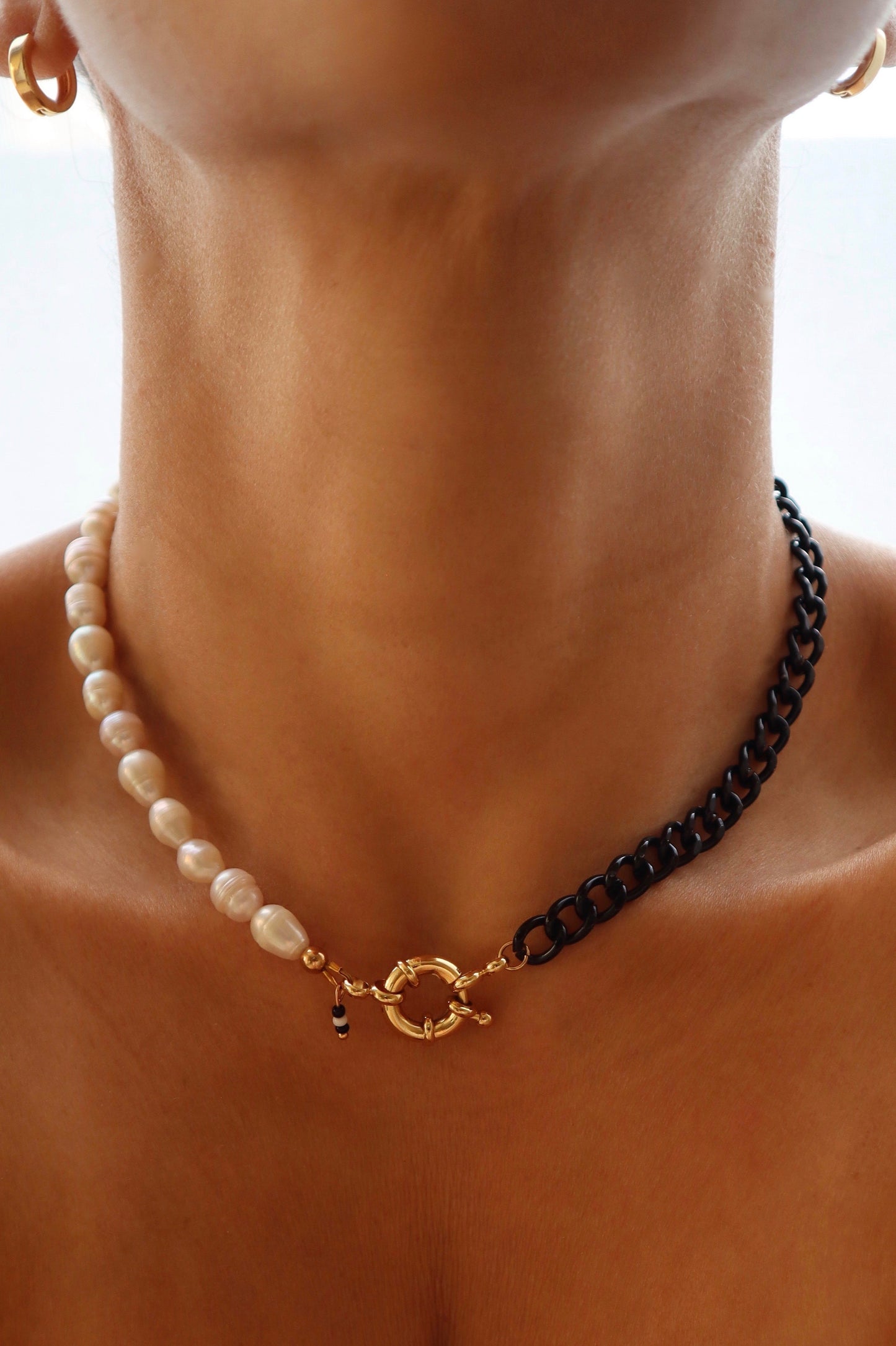 Freshwater pearls and black chain necklace displayed on model