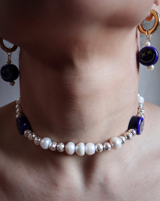 Playful statement earrings with blue smiley ceramic charms