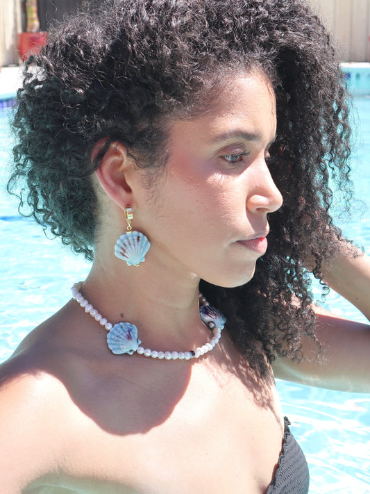 blue-ceramic-sea-shells-freshwater-pearls-necklaced-pool-lifestyle-photo-with-model