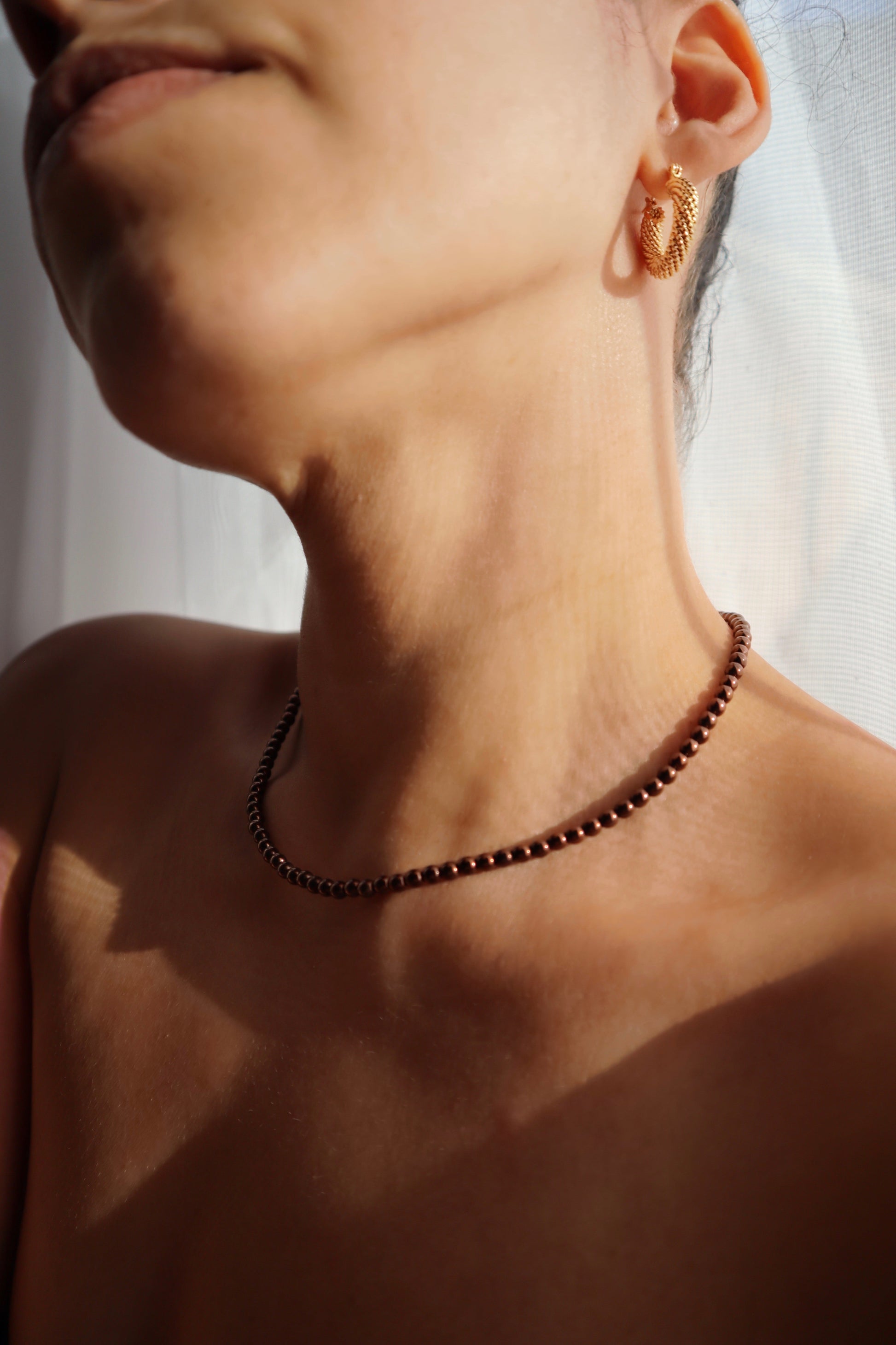 Brown glass beads necklace worn by model