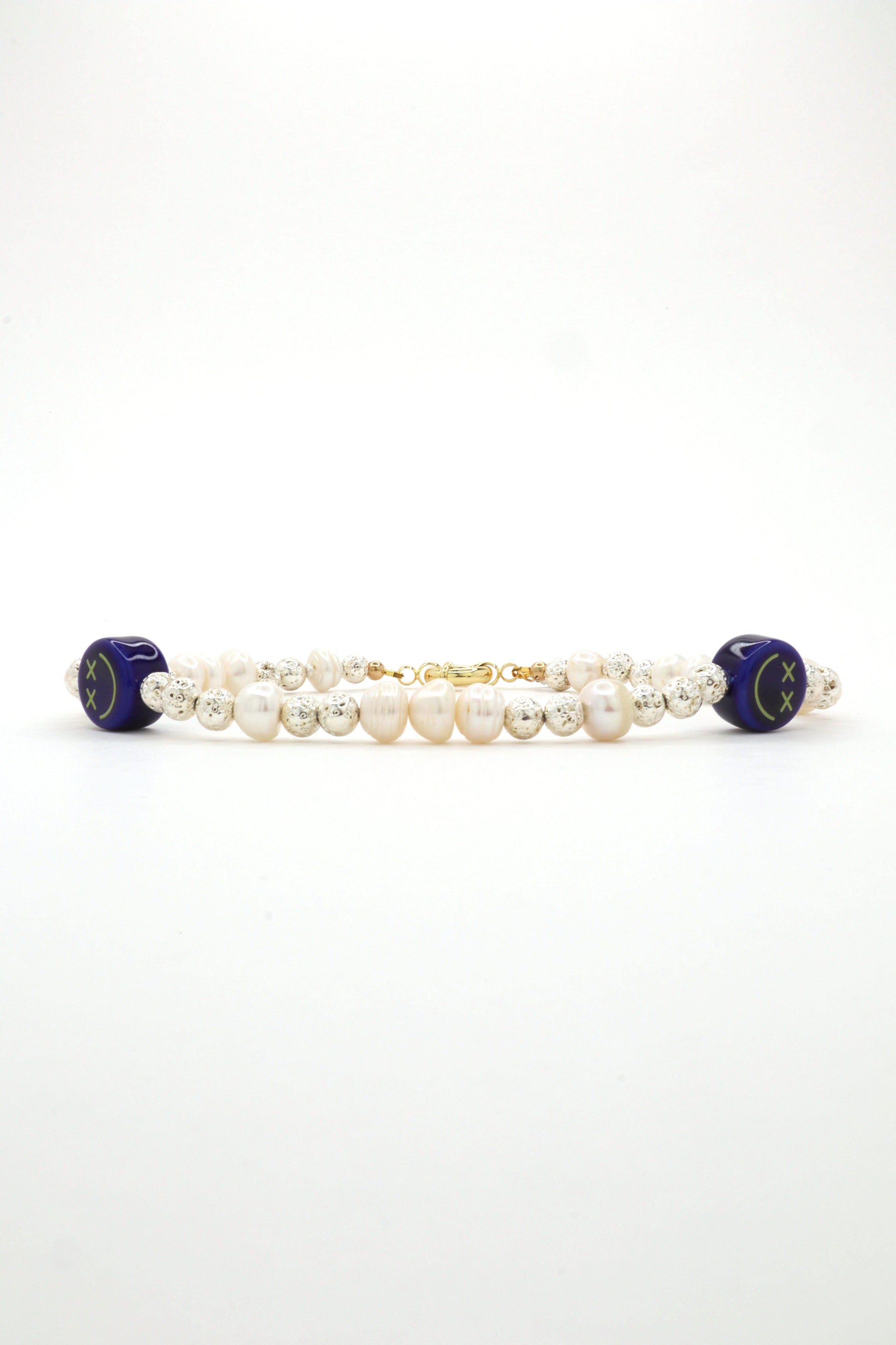 Handmade necklace with blue ceramic smiley, metallic beads, and freshwater pearls