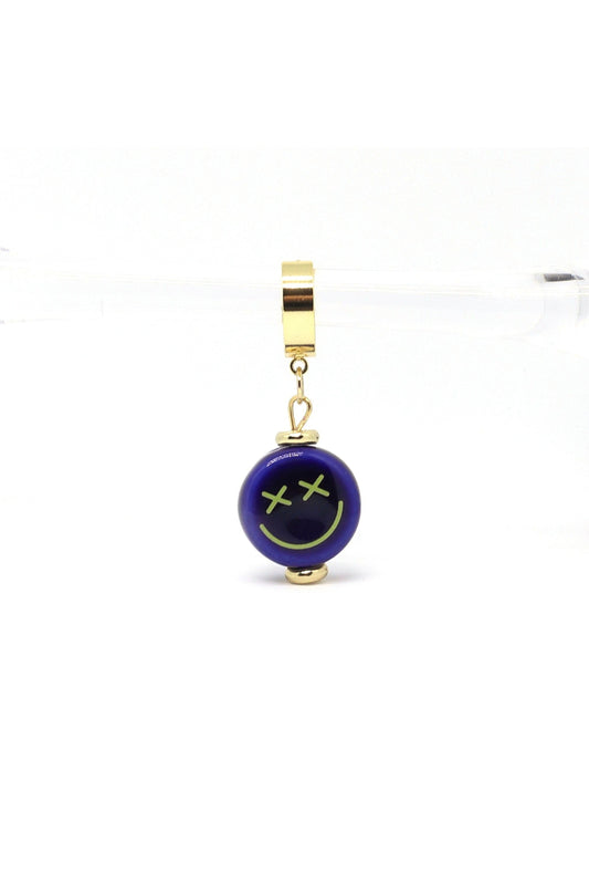 18K gold plated huggie hoops with blue ceramic smiley face charm on white background