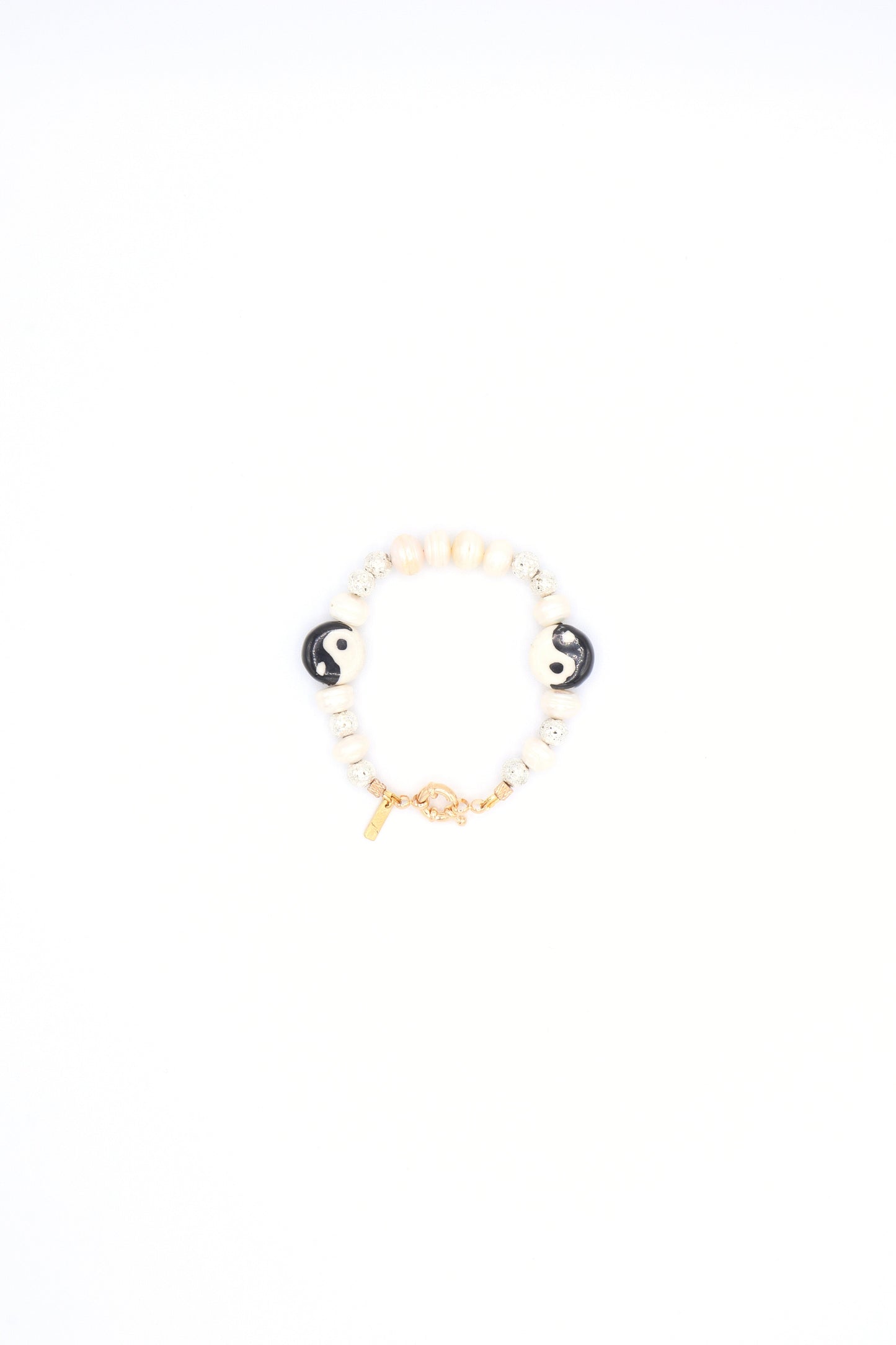 Handmade bracelet with yin yang ceramic charm, pearls, and metallic beads