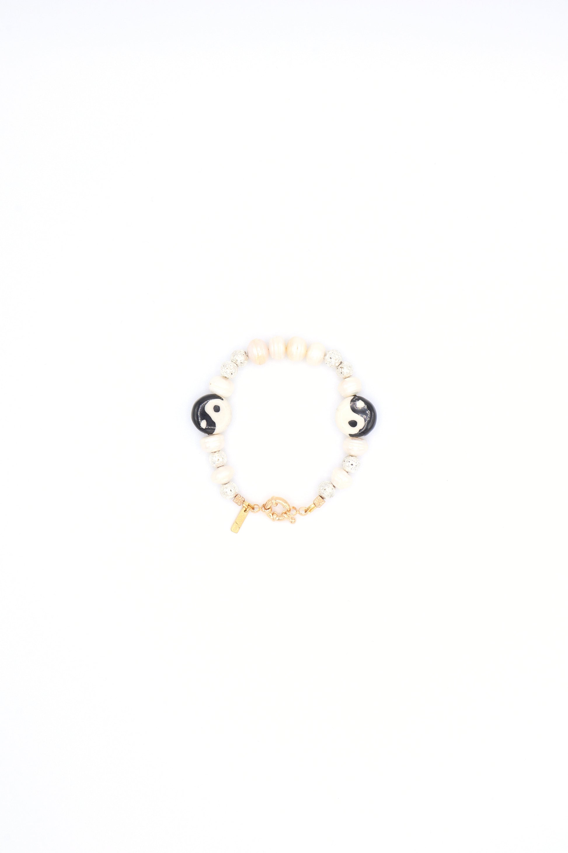 Handmade bracelet with yin yang ceramic charm, pearls, and metallic beads