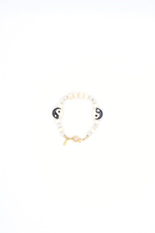 Handmade bracelet with yin yang ceramic charm, pearls, and metallic beads