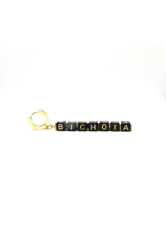 Close-up of handmade “Bichota” gold earrings on white background