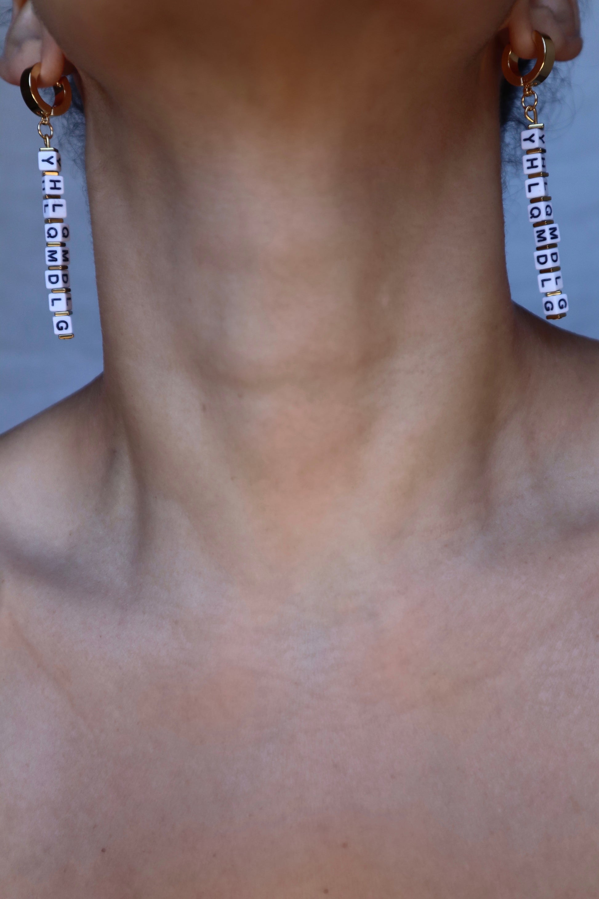 Handmade YHLQMDLG huggie hoops in gold on model