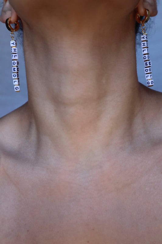 Handmade YHLQMDLG huggie hoops in gold on model
