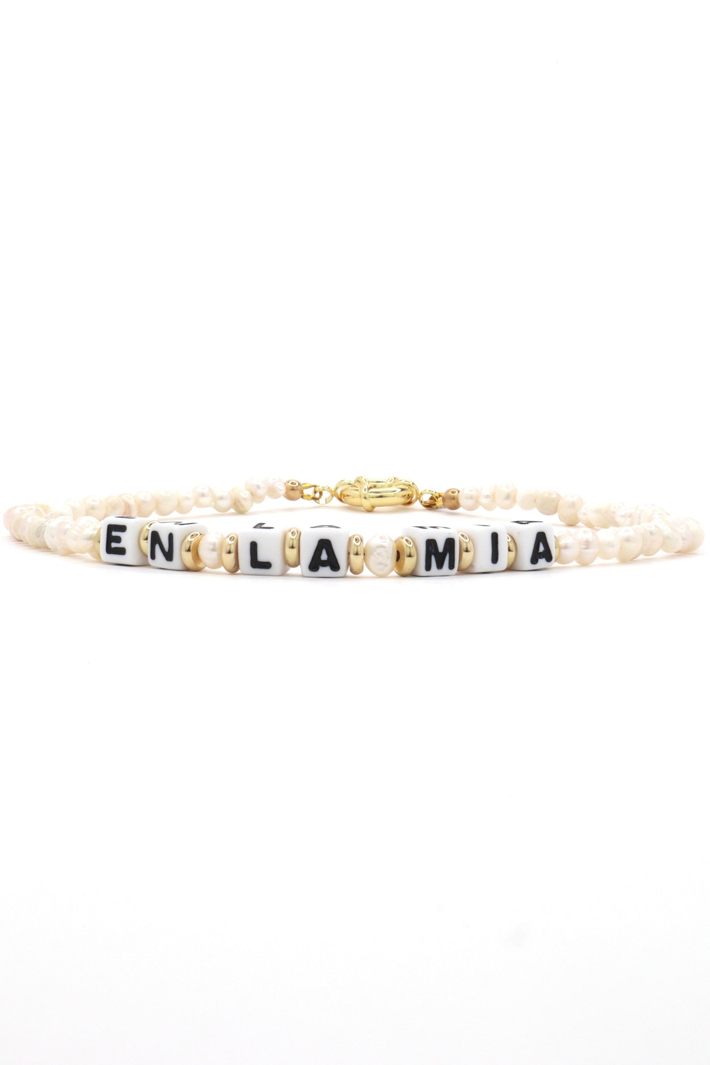 Close-up of customizable gold and pearl name necklace