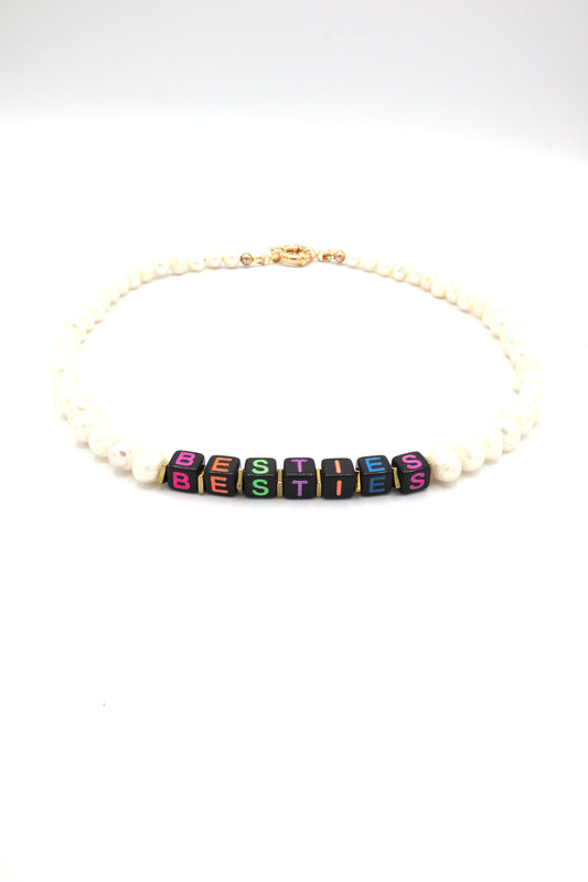 Custom freshwater pearl necklace with neon cube letters spelling 'besties'