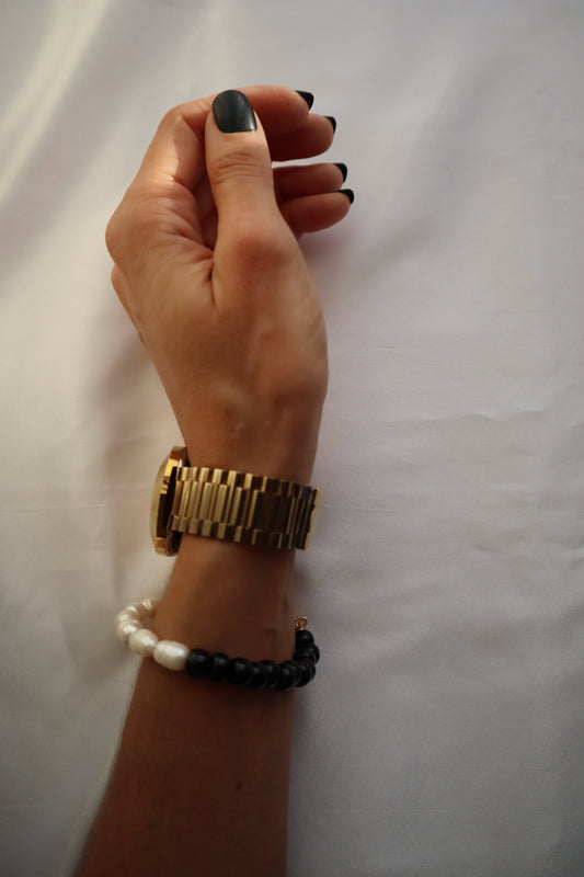 Wrist shot of handcrafted black glass and pearl bracelet