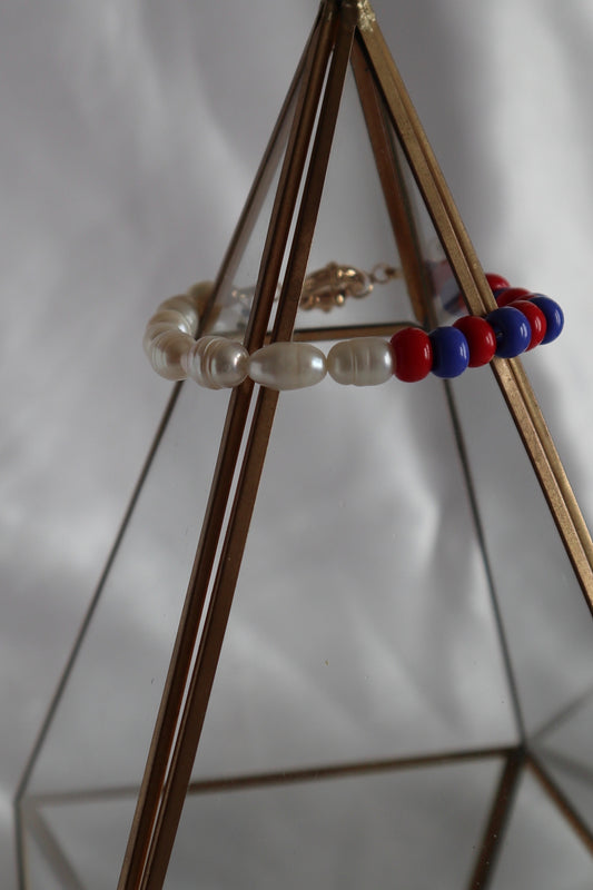 freshwater pearls with blue and red glass beads bracelet displayed on prop