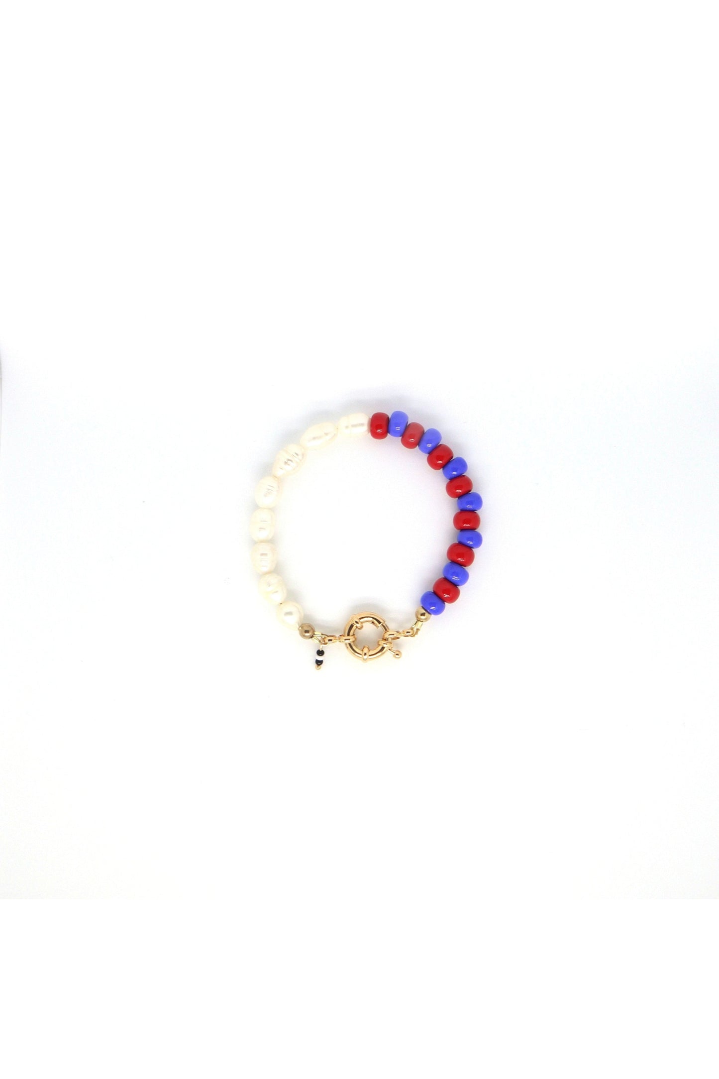 freshwater pearls with blue and red glass beads bracelet laying flat on white background