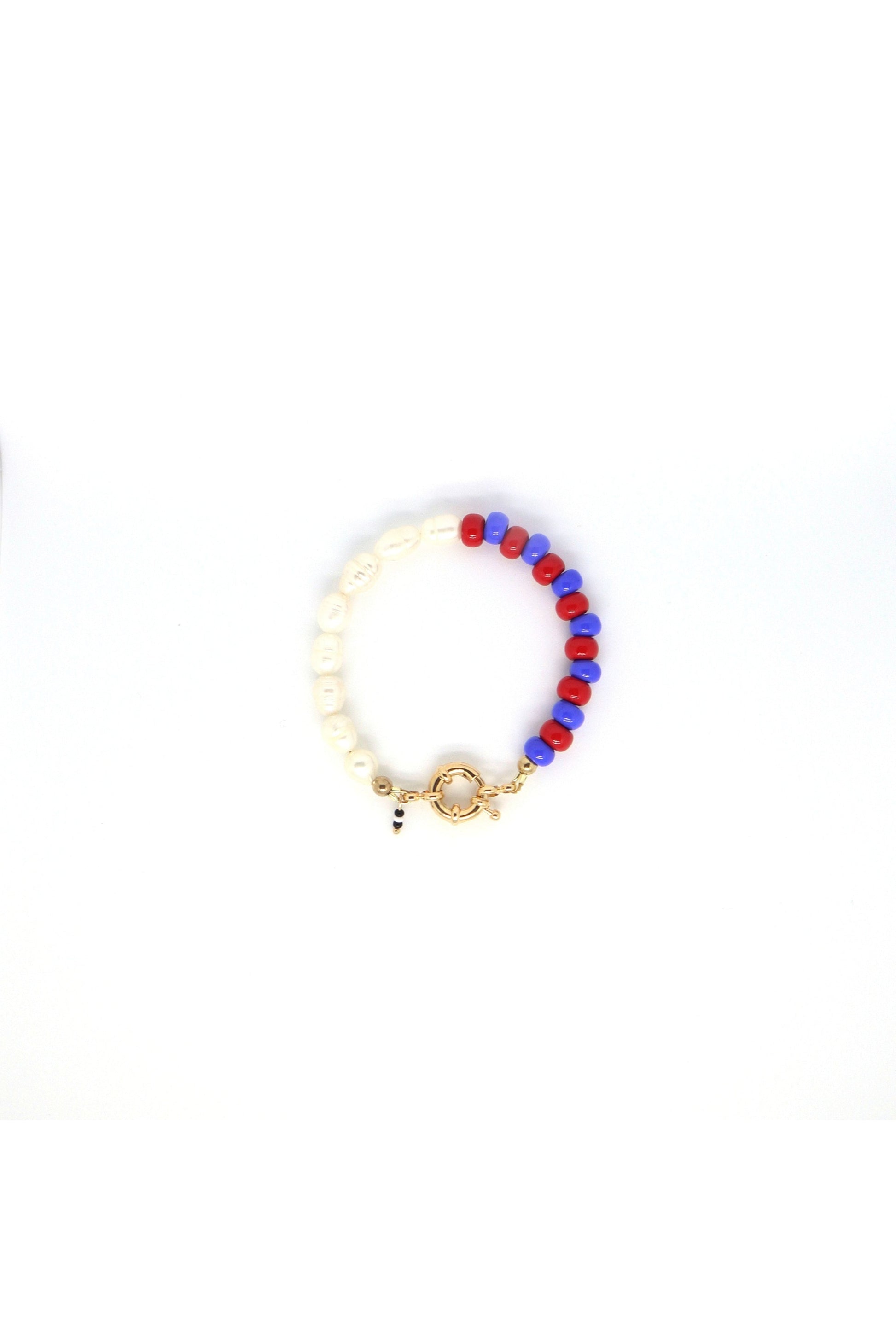 freshwater pearls with blue and red glass beads bracelet laying flat on white background
