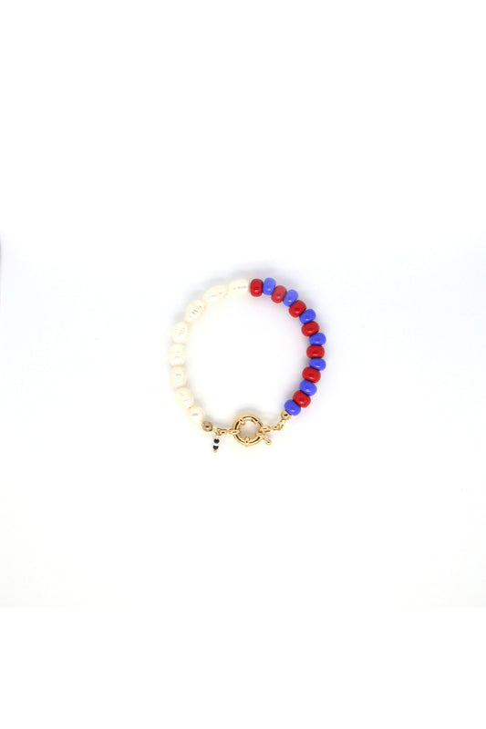 freshwater pearls with blue and red glass beads bracelet laying flat on white background