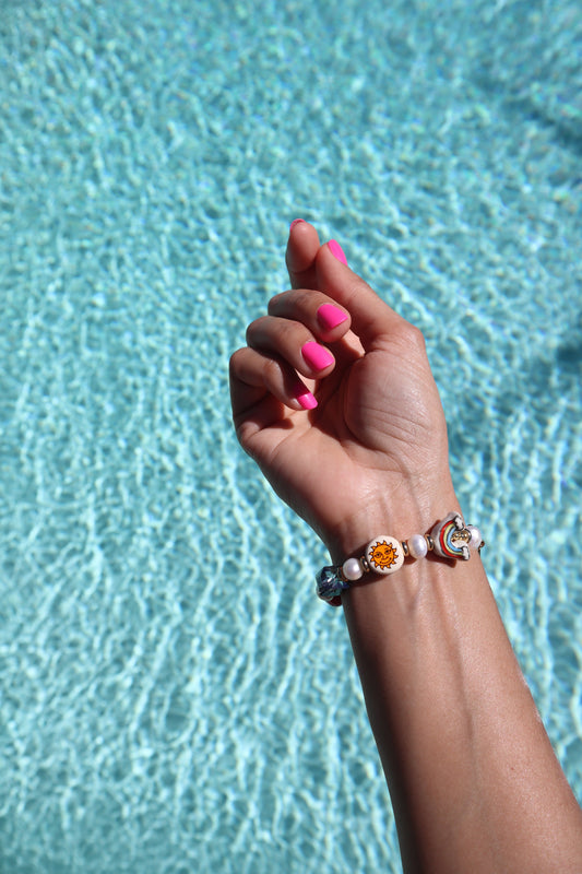 freshwater-pearls-ceramic-heart-mermaid-sun-rainbow-beads-iridescent-blue-glass-stone-pool-lifestyle-photo