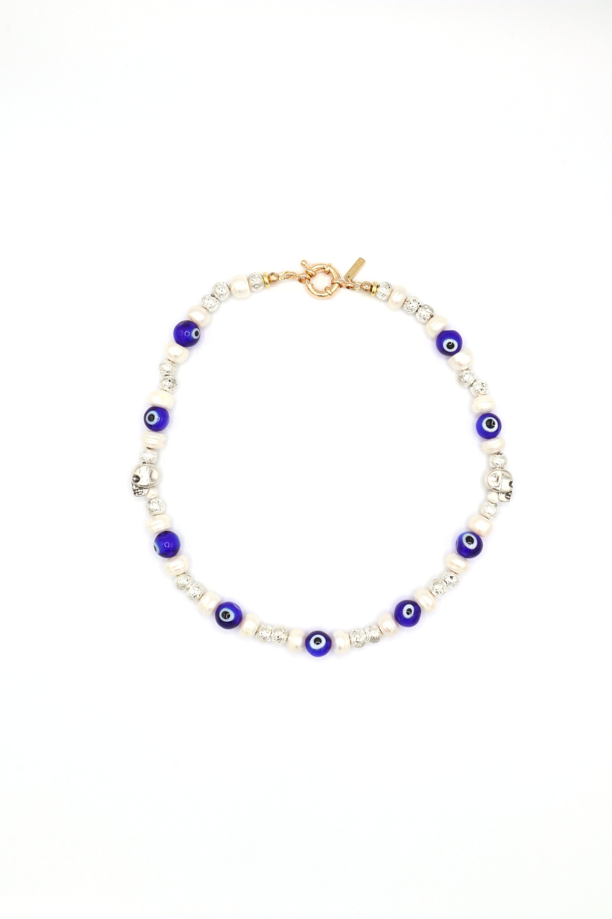 Handmade evil eye necklace with metal skull, pearls, and lava beads