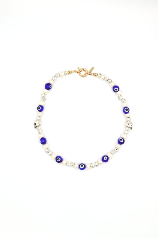 Handmade evil eye necklace with metal skull, pearls, and lava beads