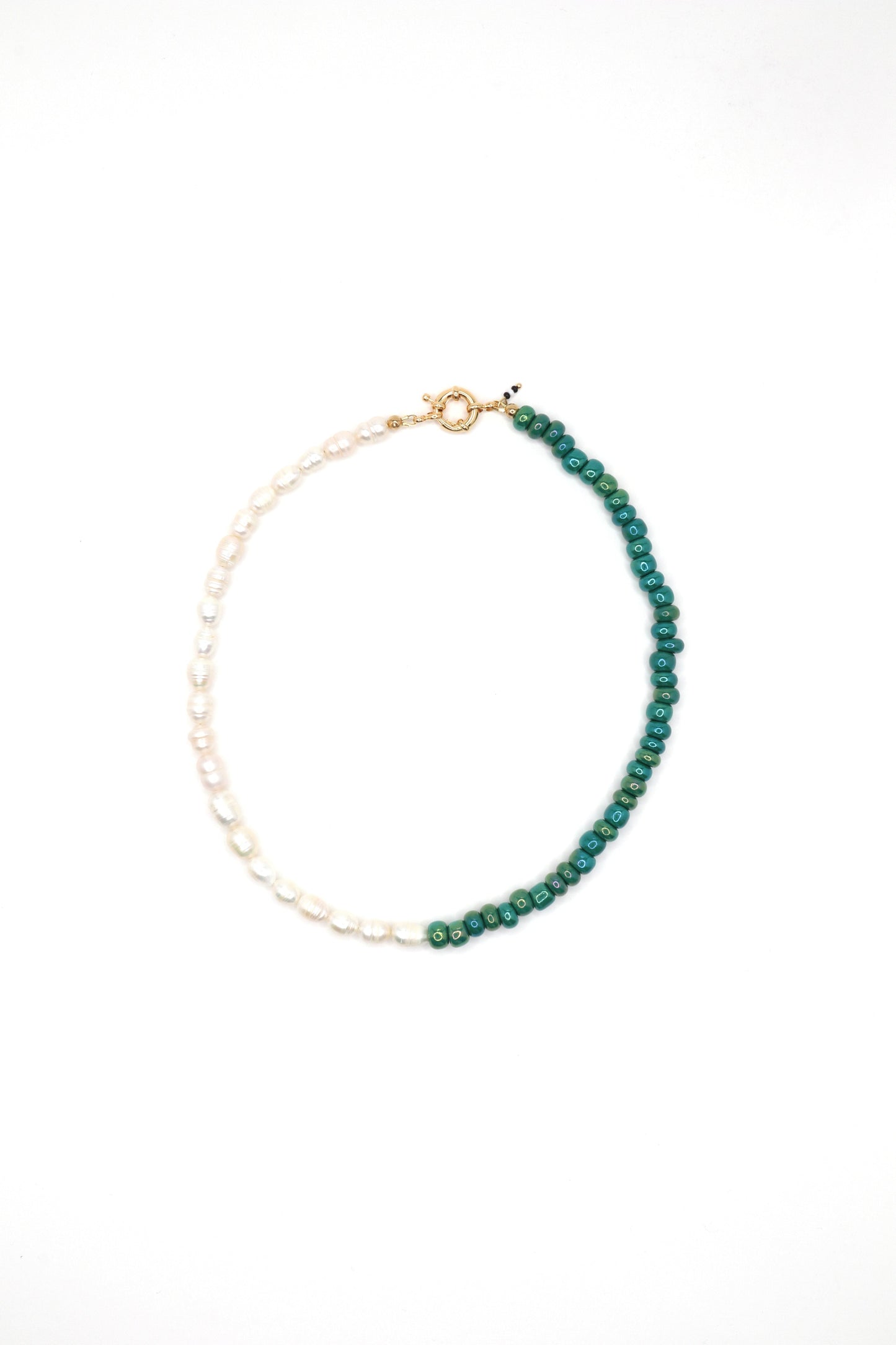 Flat lay of handmade green glass and pearl beaded necklace