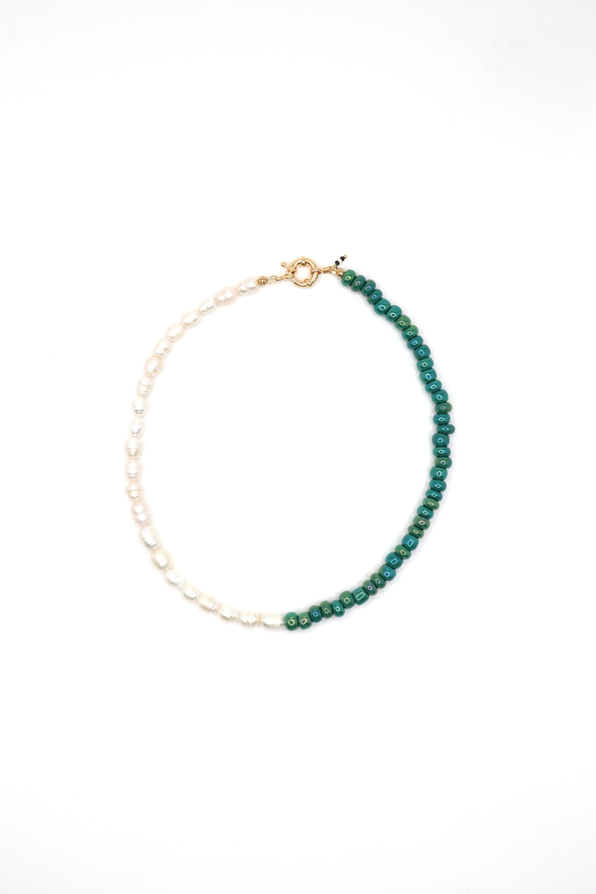 Flat lay of handmade green glass and pearl beaded necklace
