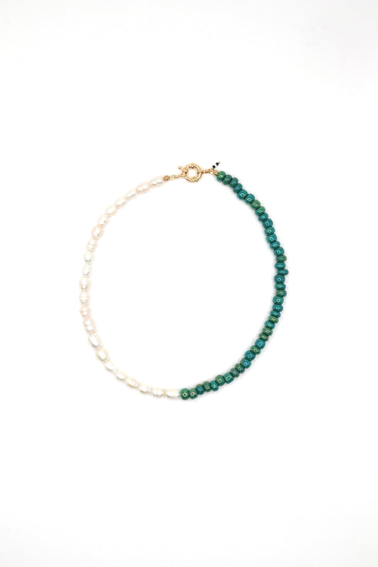 Flat lay of handmade green glass and pearl beaded necklace