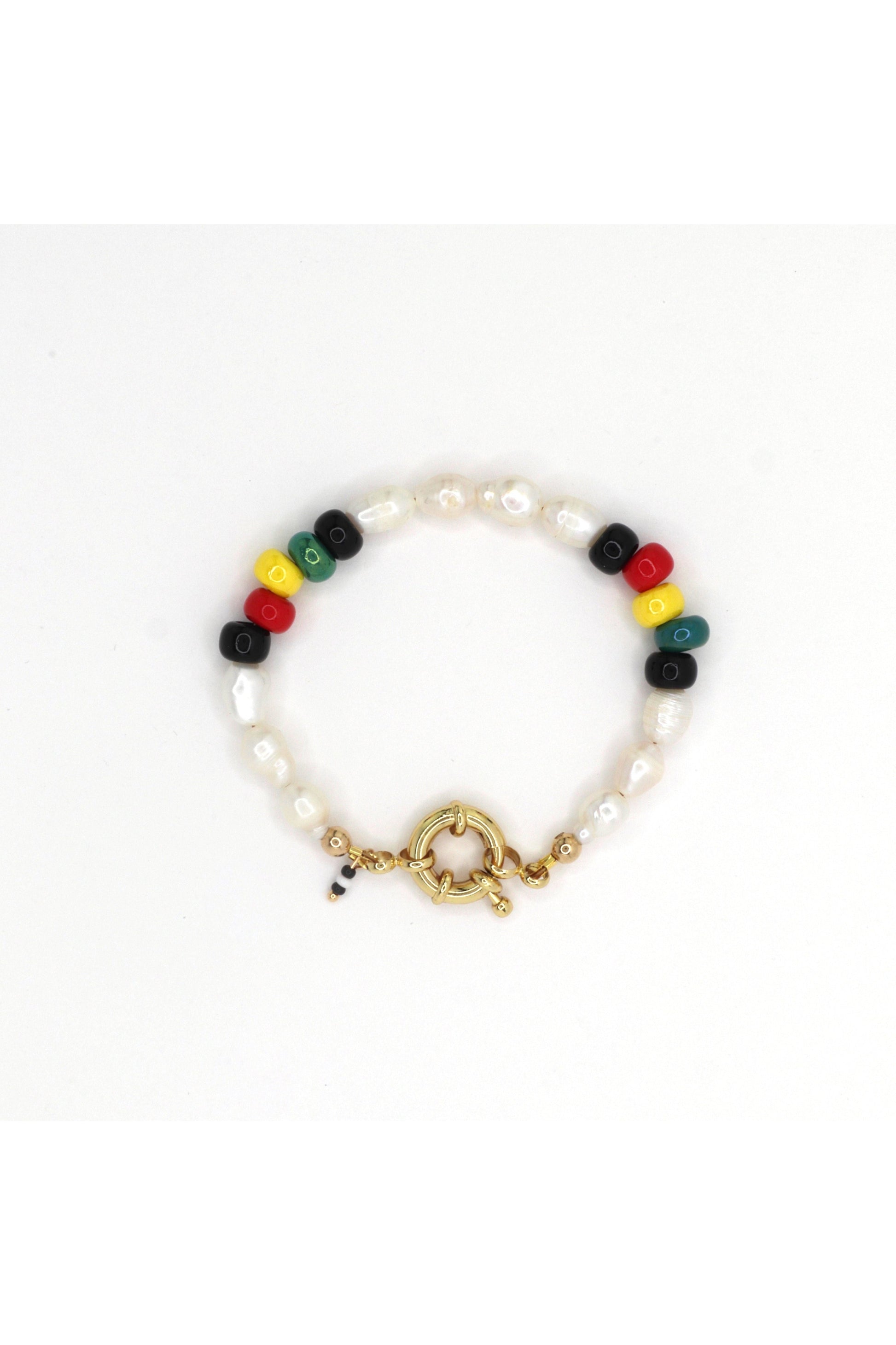 Rasta-inspired bracelet with glass beads and freshwater pearls on white background by Nayda De Jesus