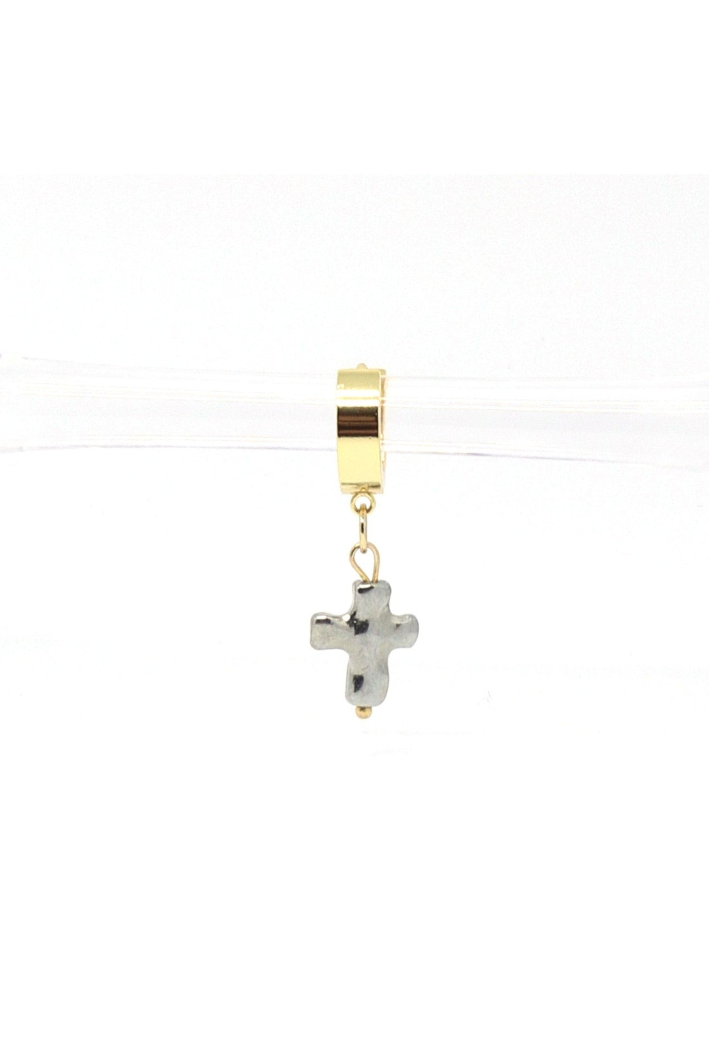18K gold plated cross dangle huggies on white background by Nayda De Jesus