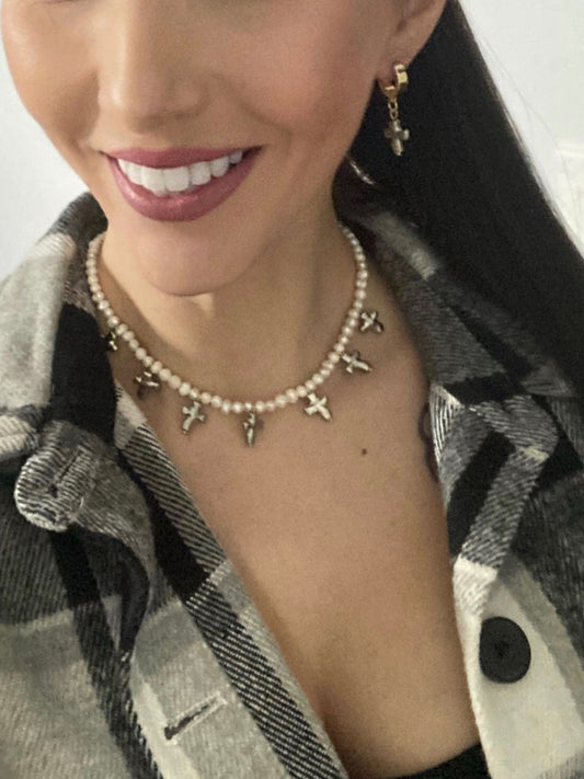 Freshwater pearl and silver cross necklace displayed on model