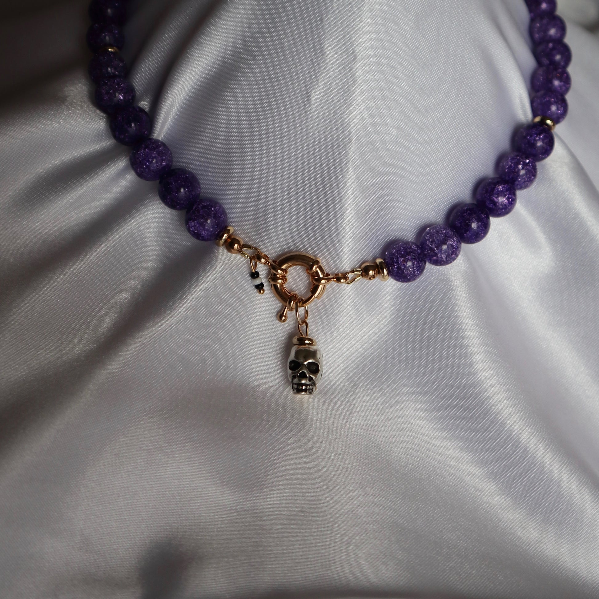 Bold metal skull charm displayed with a necklace