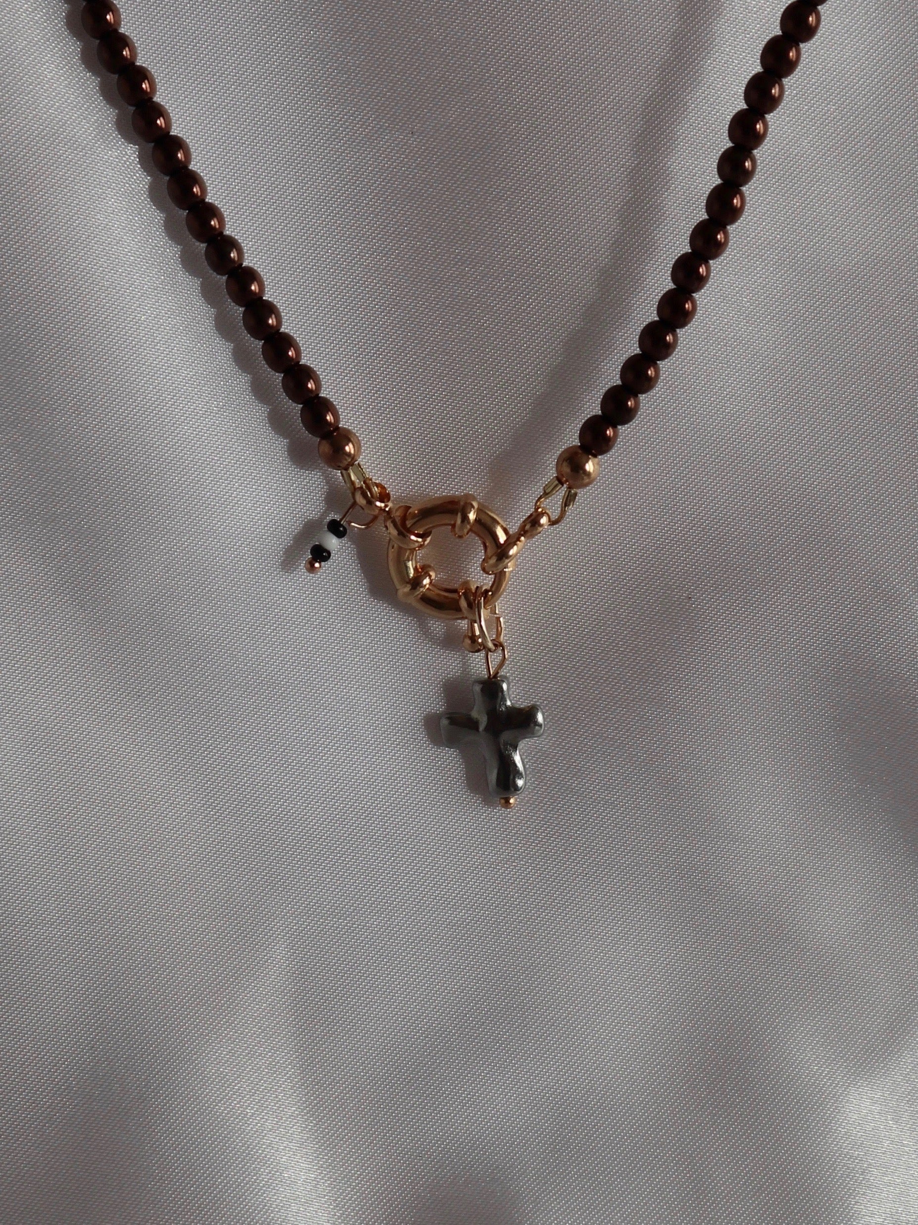 Silver cross pendant charm on necklace handmade by Nayda De Jesus