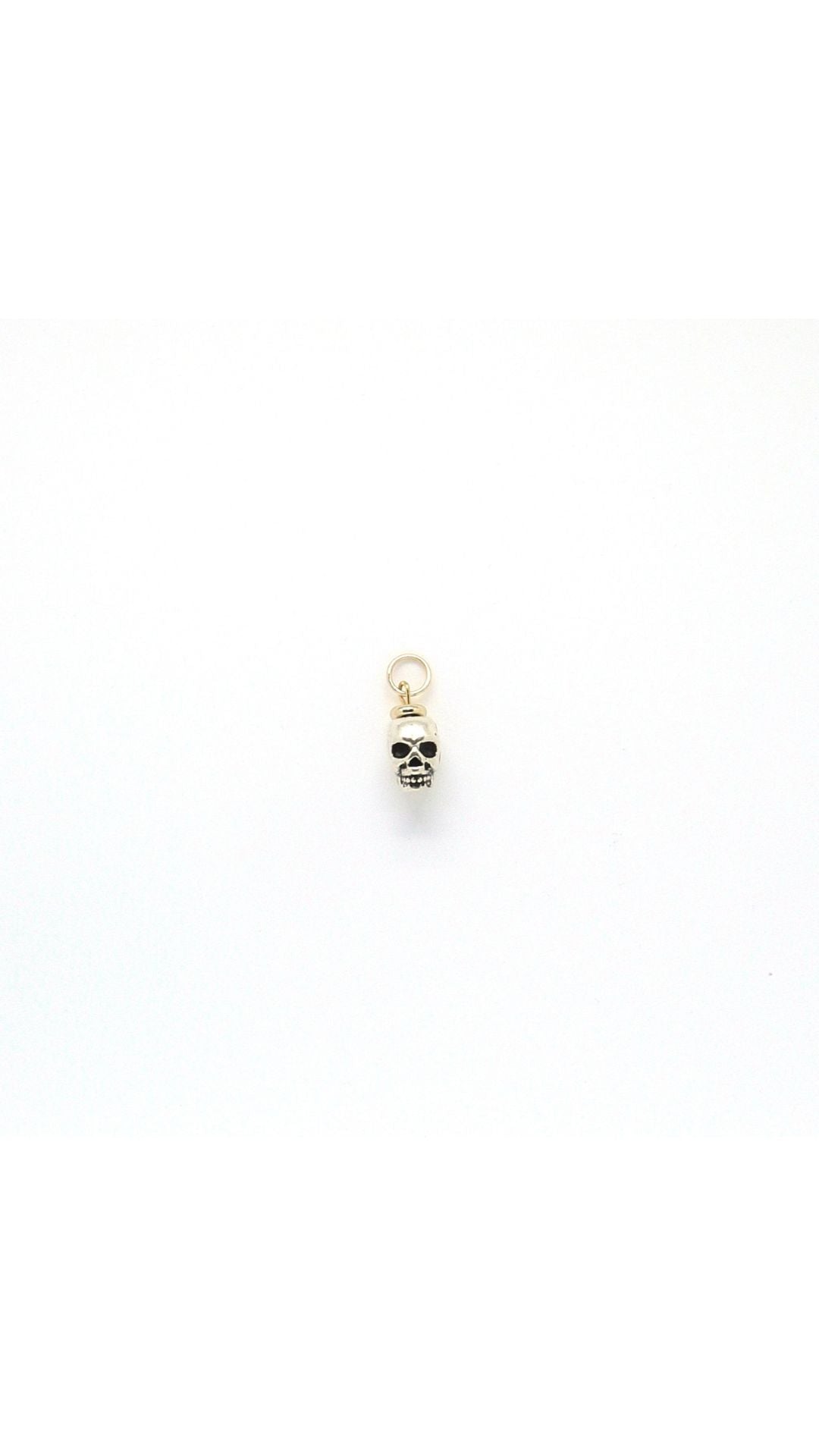 Handmade metal skull charm pendant by Nayda De Jesus
