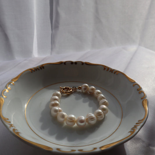 Close-up of oversized natural pearls on chunky bracelet