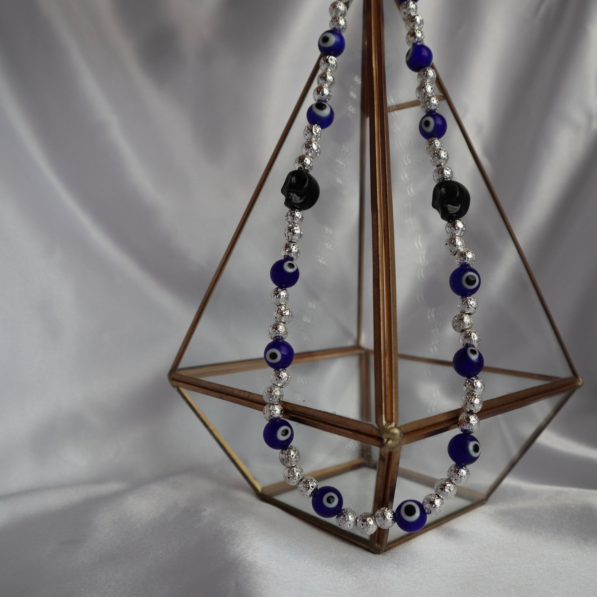 Handmade protective evil eye necklace with skull and lava beads by Nayda De Jesus