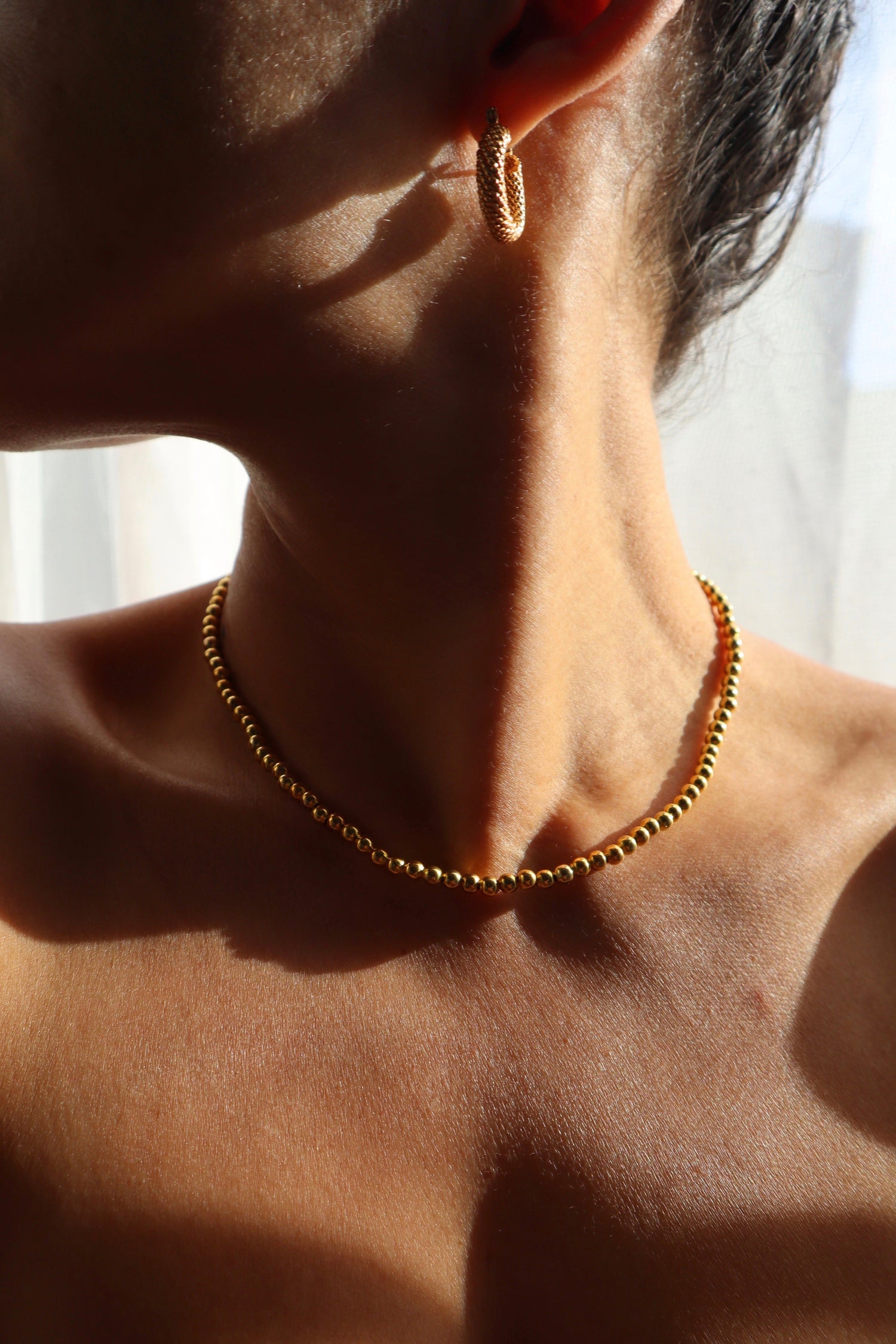 22k gold plated beaded necklace handmade displayed on model by Nayda De Jesus