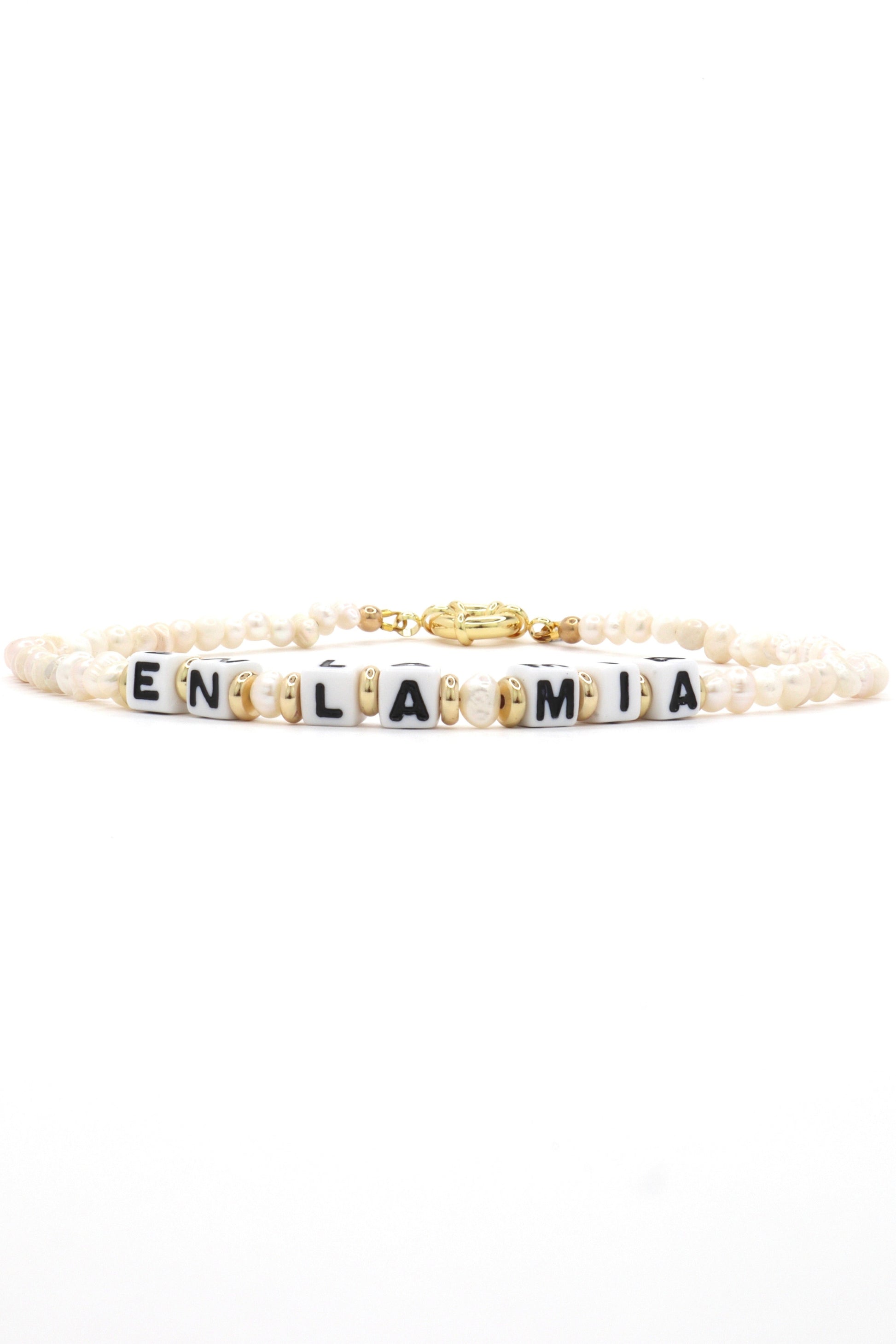 Close-up of customizable gold and pearl name necklace