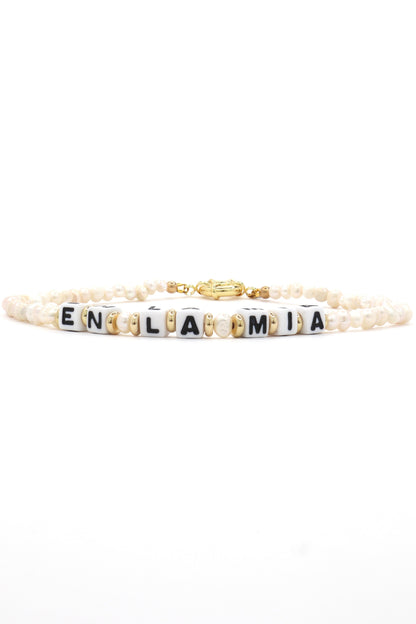 Close-up of customizable gold and pearl name necklace