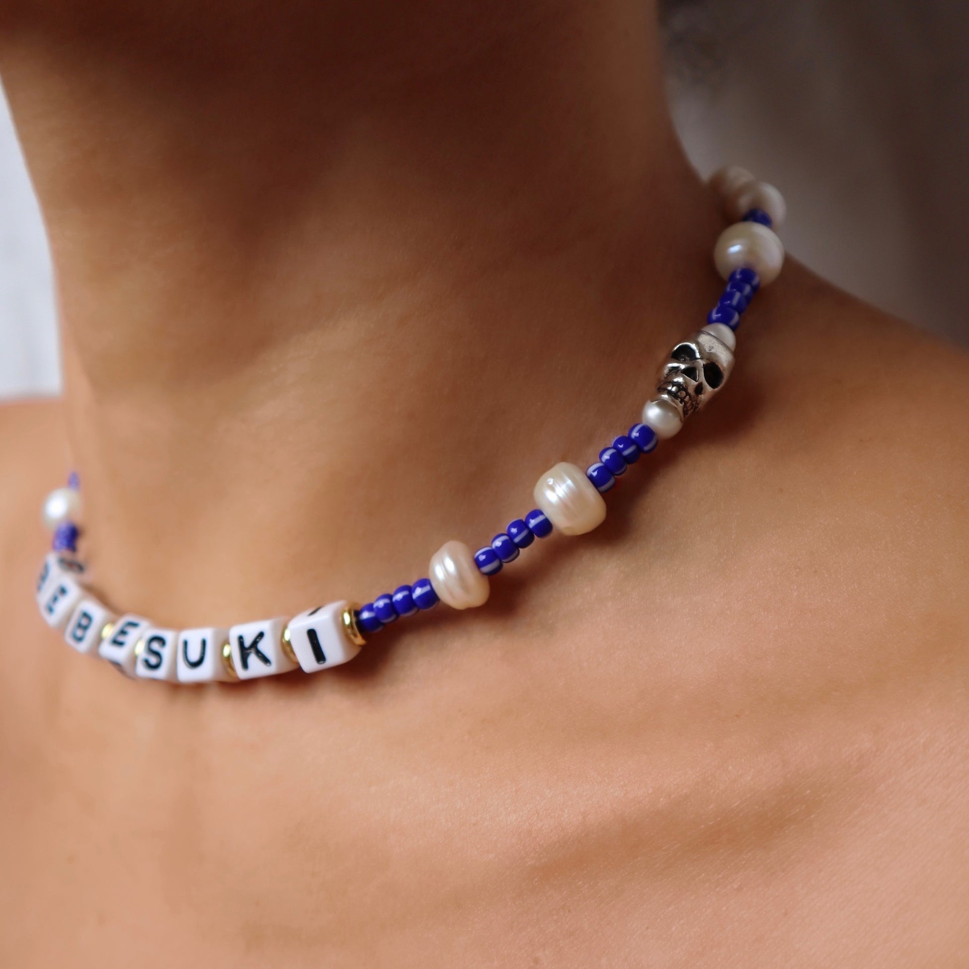 Handmade bebesuki necklace by Nayda De Jesus with pearls and skull charm