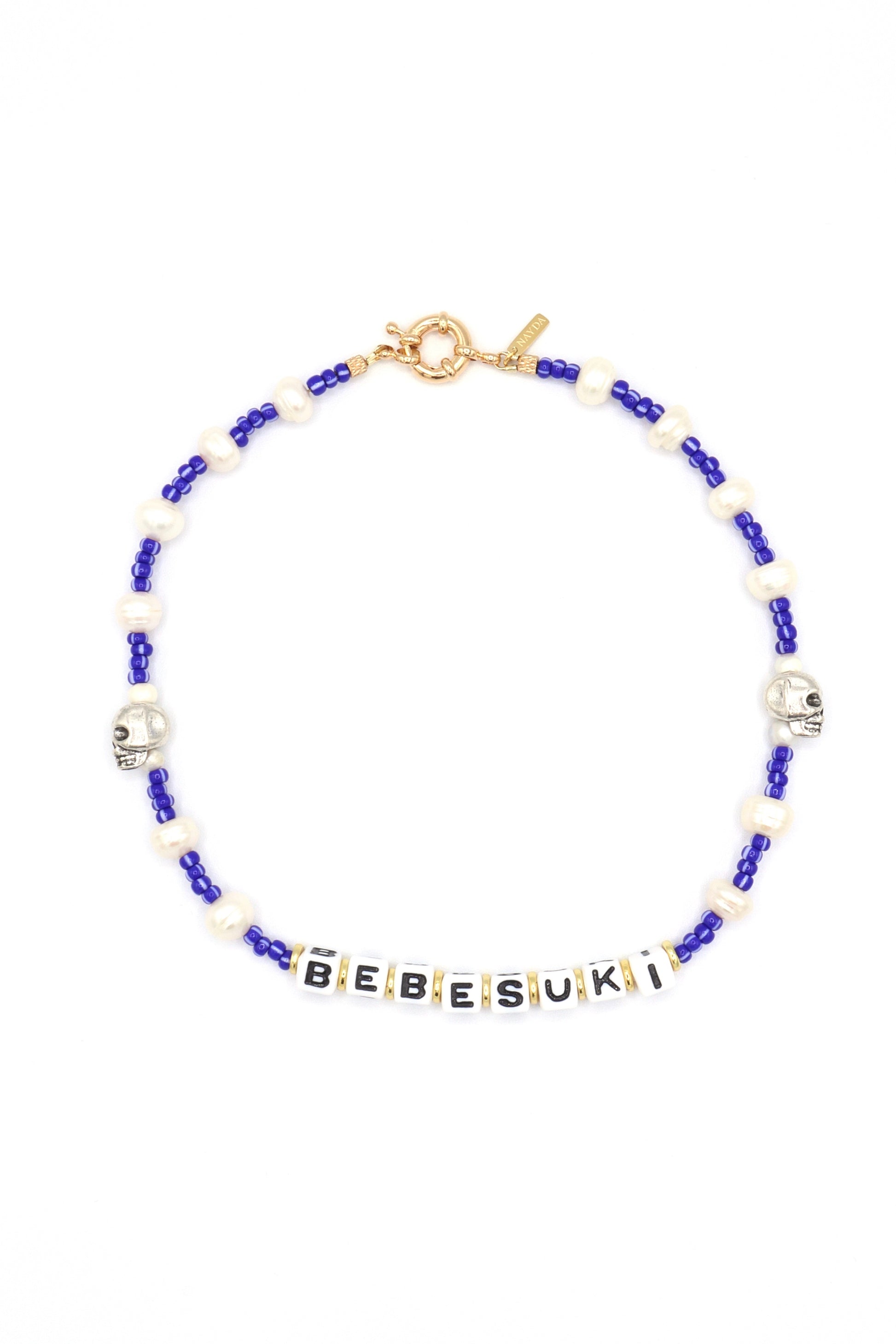 Handmade bebesuki necklace by Nayda De Jesus with pearls and skull charm