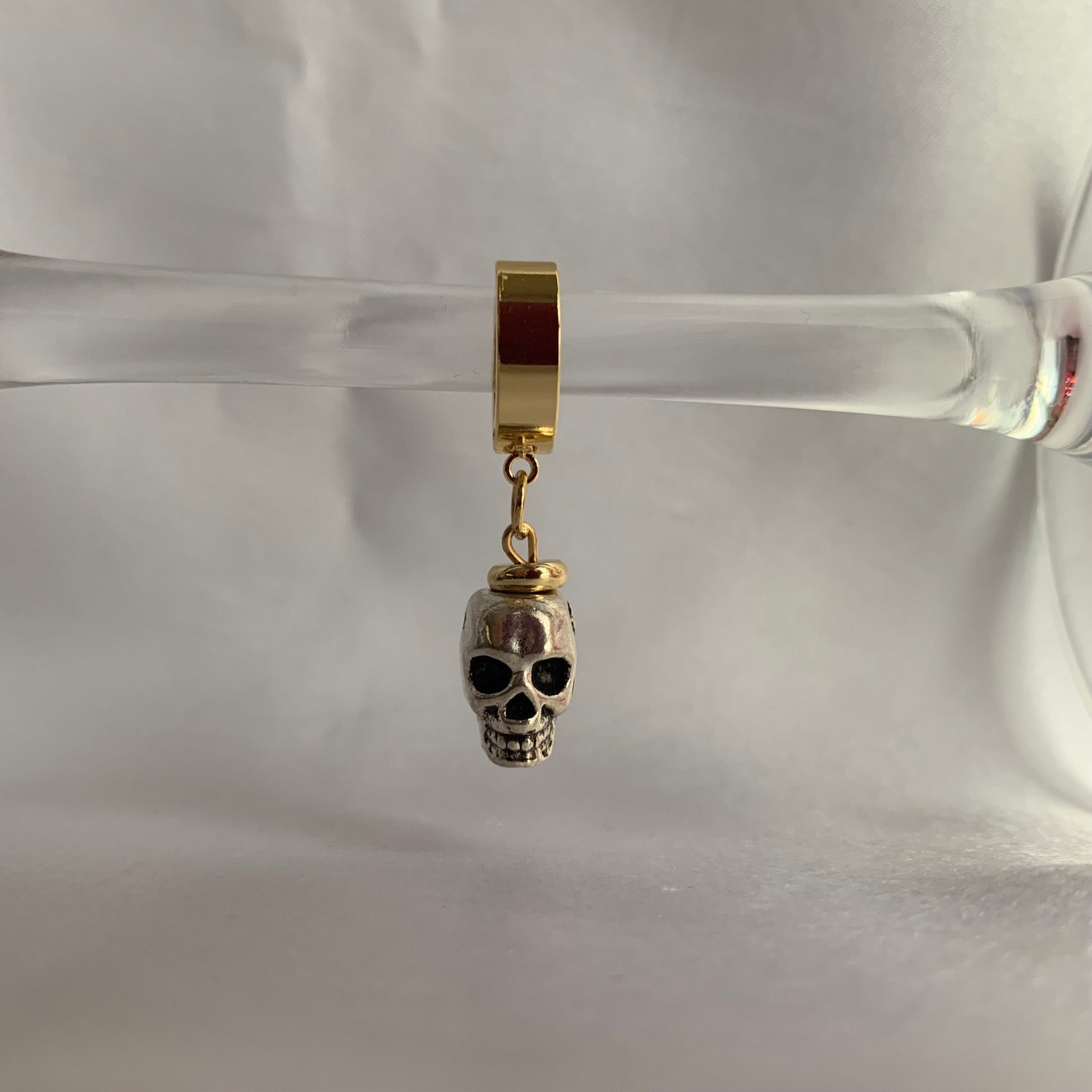 lifestyle-photo-of-the-t-1000-earrings-hand-made-with-metal-skull-and-18-k-gold-plated-huggie-hoops-by-latina-artist-nayda-de-jesus