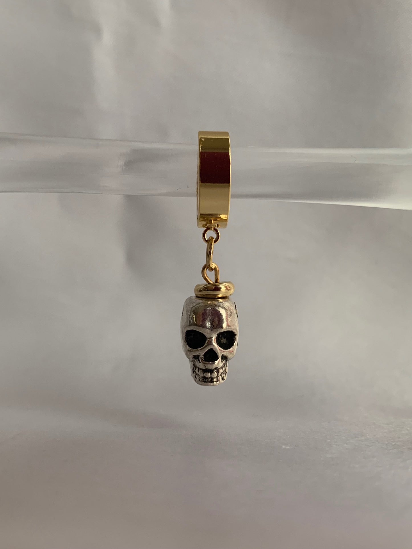 18K gold-plated skull dangle huggie hoops by Nayda De Jesus