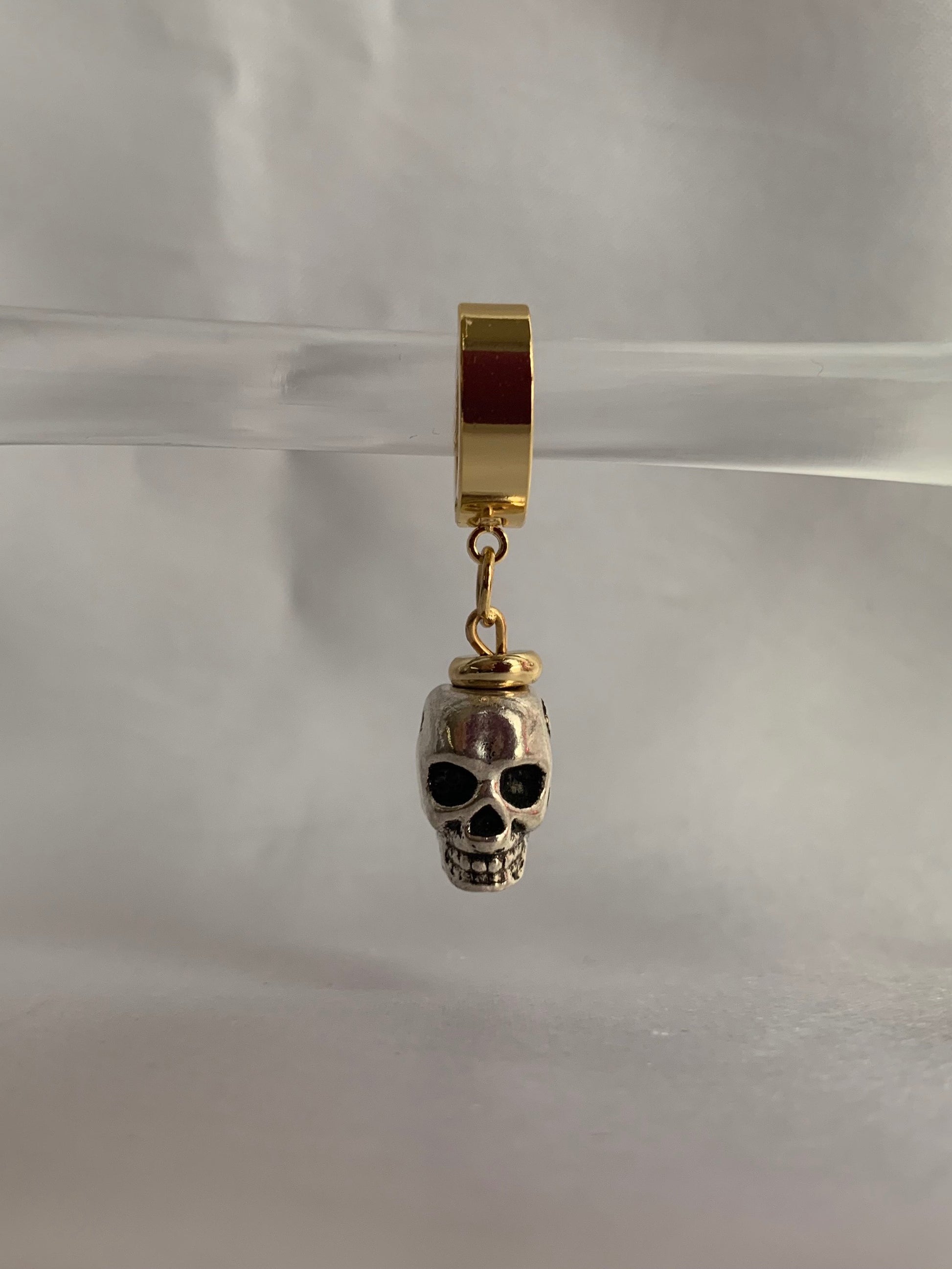 18K gold-plated skull dangle huggie hoops by Nayda De Jesus