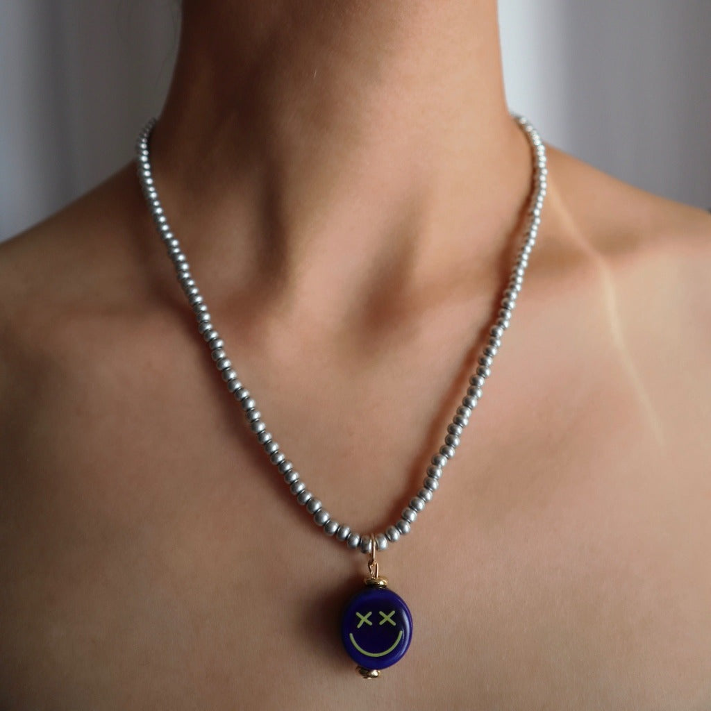 luna-necklace-made-with-silver-metallic-beads-with-alejandro-smiley-face-charm-by-nayda-de-jesus