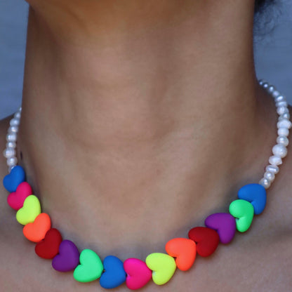 lifestyle-photo-of-venus-necklace-hand-made-with-rainbow-colored-hearts-and-freshwater-pearls-along-18-k-spring-clasp-closure-by-latina-artist-nayda-de-jesus